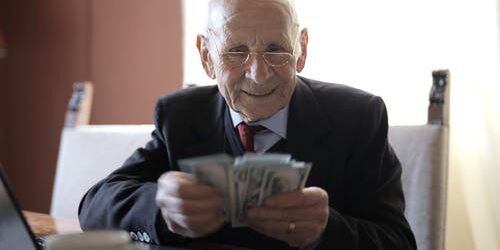 an elderly man counting his money